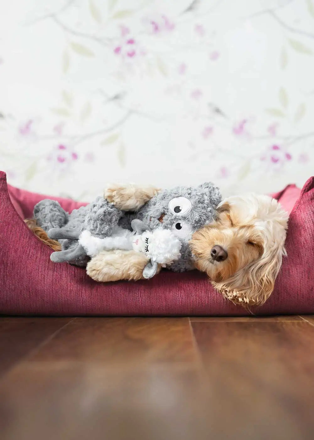Cute dog cuddling with her teddy bear plush toy 